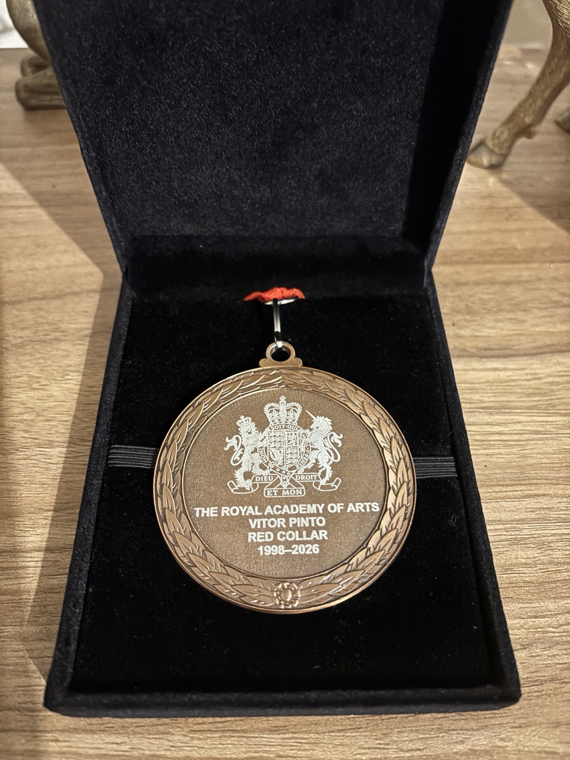 Personalised long-service medal with a crest, name and dates in its presentation box