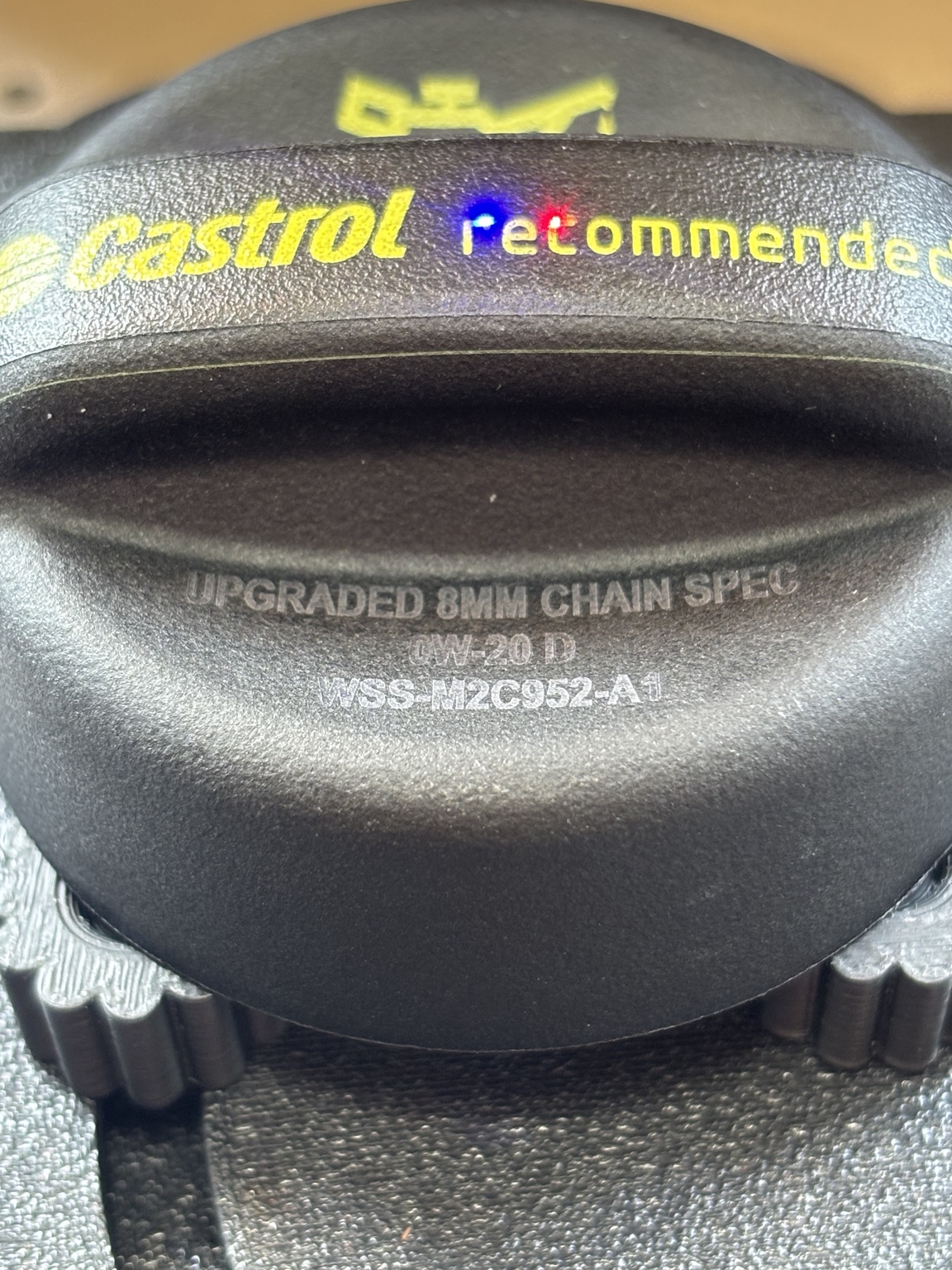 Close-up of the custom specification text laser marked on the oil cap